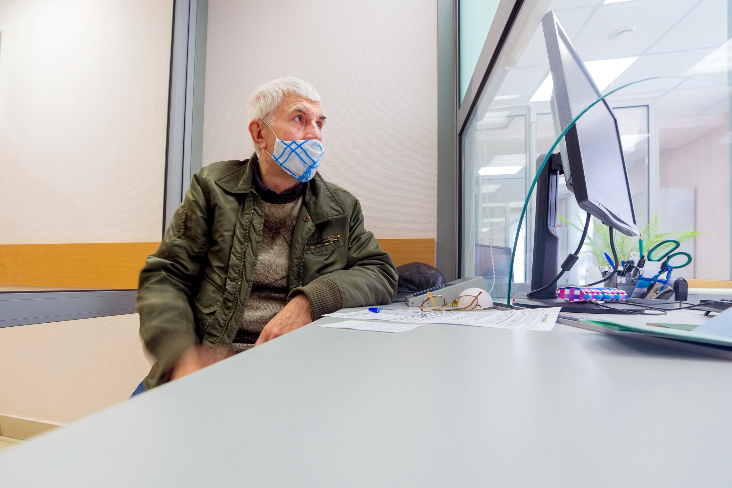 Elderly man waiting to learn more about his retirement and workers comp benefits