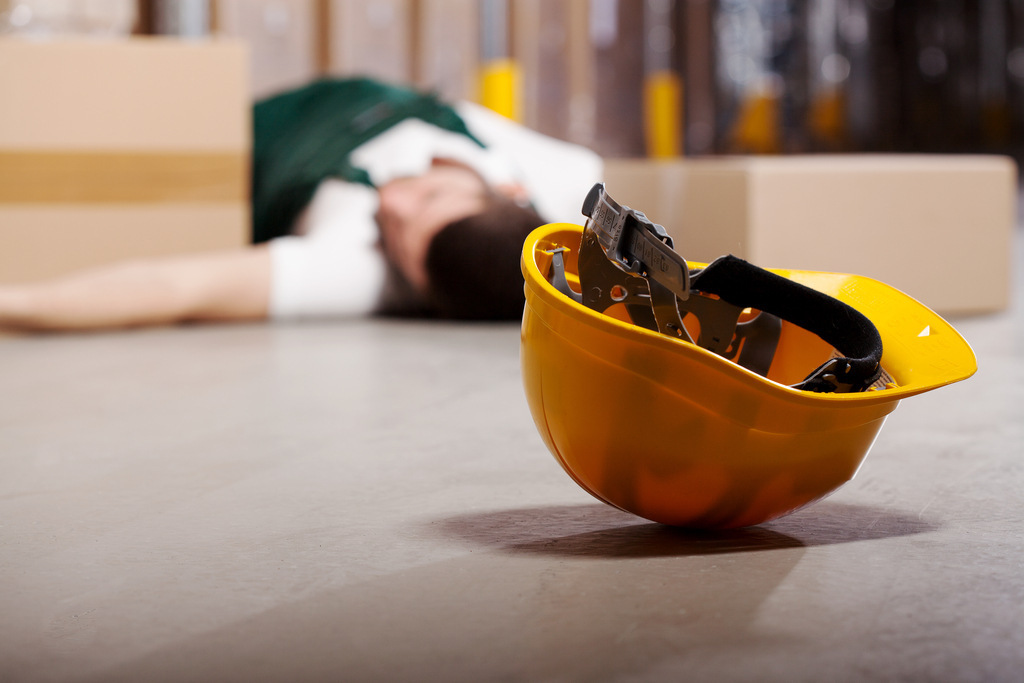 Man on the floor after suffering workplace accident