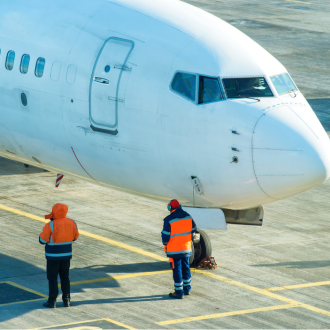airport service staff near an airplane