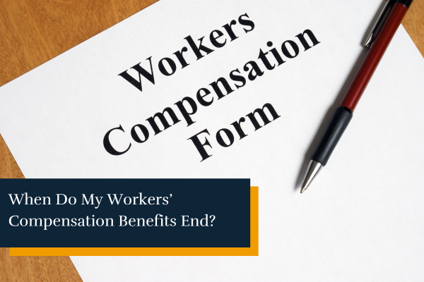 workers compensation claim form and a pen