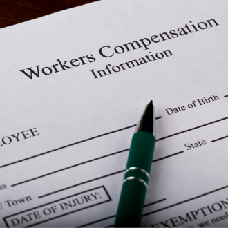 workers compensation information sheet with a pen on a table