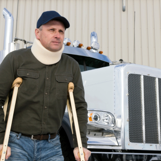 an injured truck driver in front of his truck