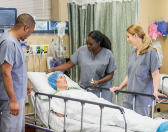 a group of healthcare workers surrounding a patient in the hospital